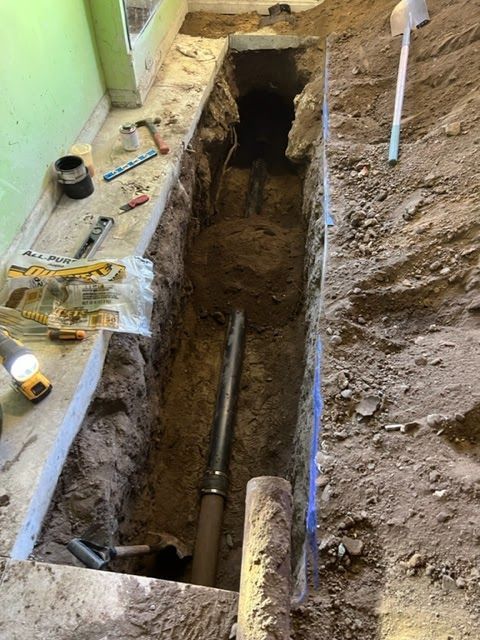 A pipe is being installed in a hole in the ground.
