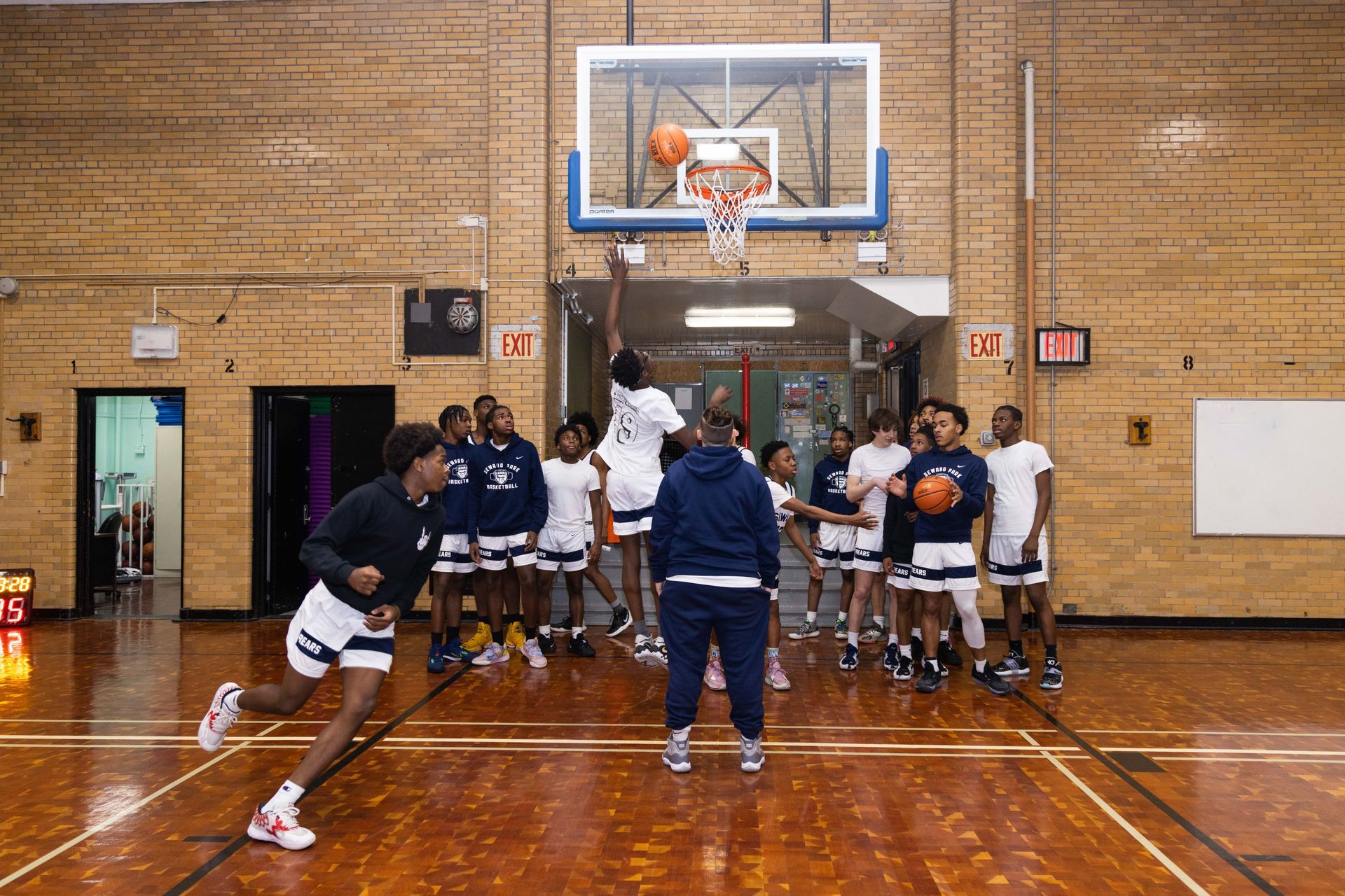 Student basketball players running drills.