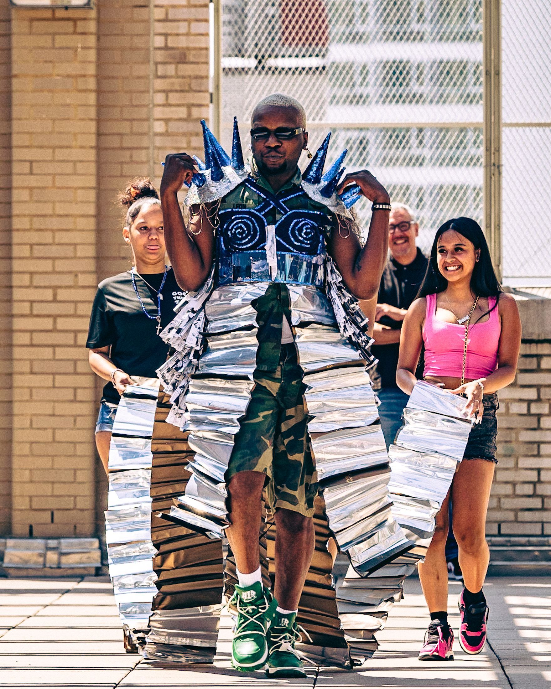 Host in a student-made garment at the 2023 Sustainable Fashion Show at New Design High School. Photo by Luis Suarez