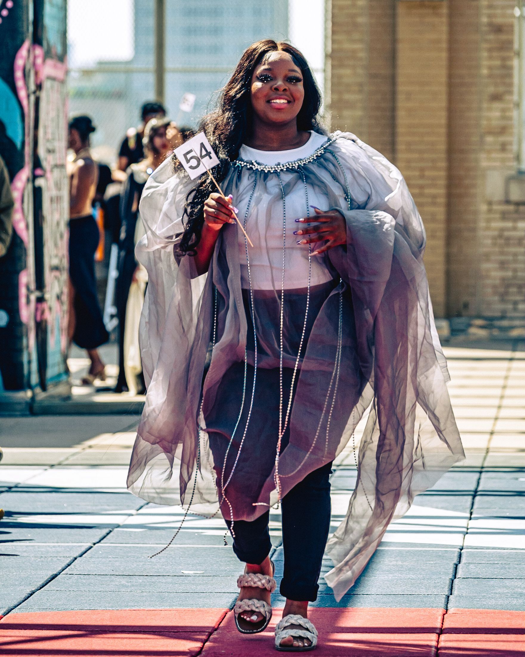 Model in hand-made garment at the 2023 Sustainable Fashion Show at New Design High School. Photo by Luis Suarez