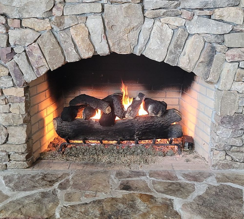 a fireplace with a lot of logs in it