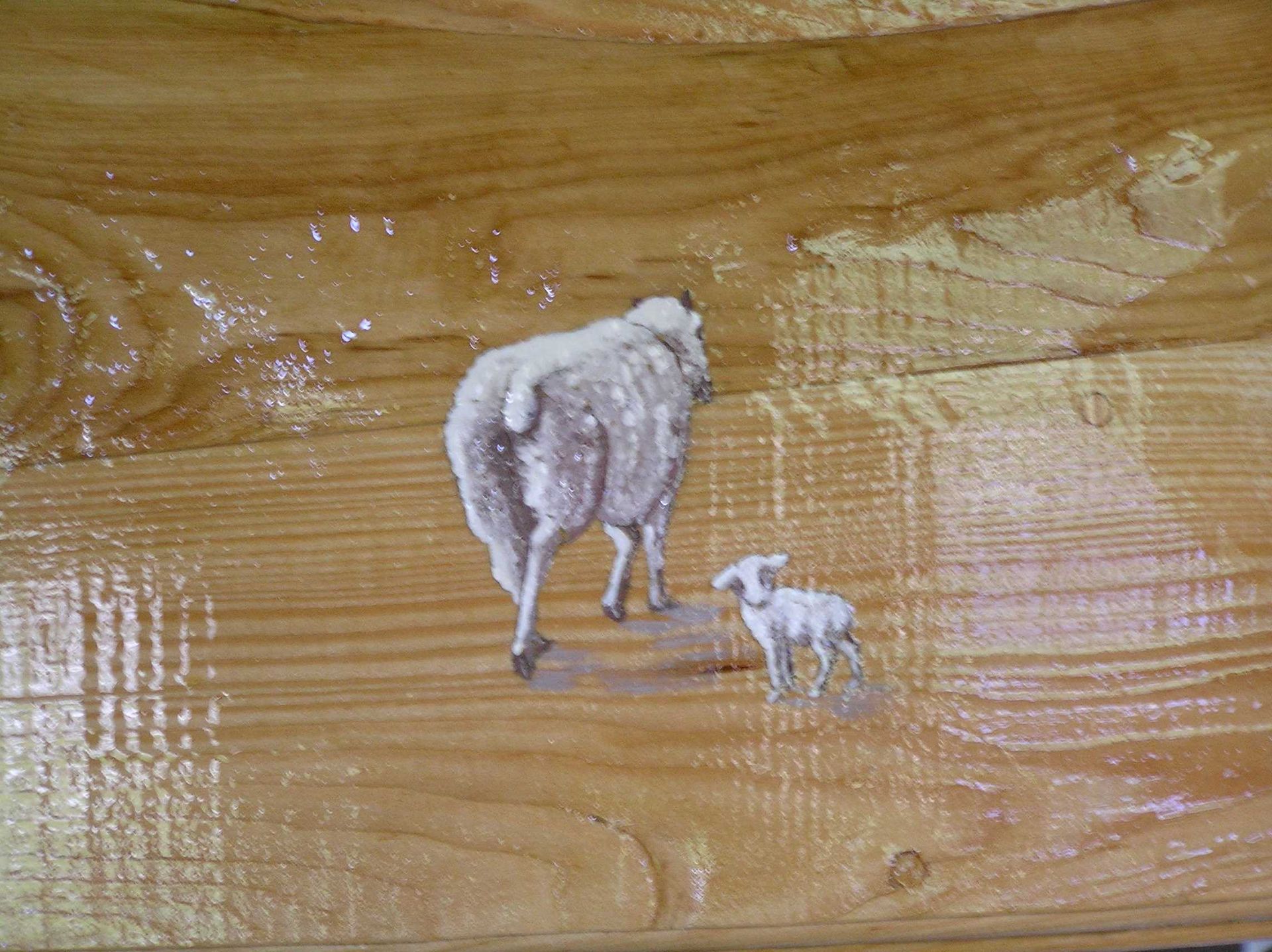 Hand painted illustration of a ewe and lamb on a wooden house sign by Ingrained Culture
