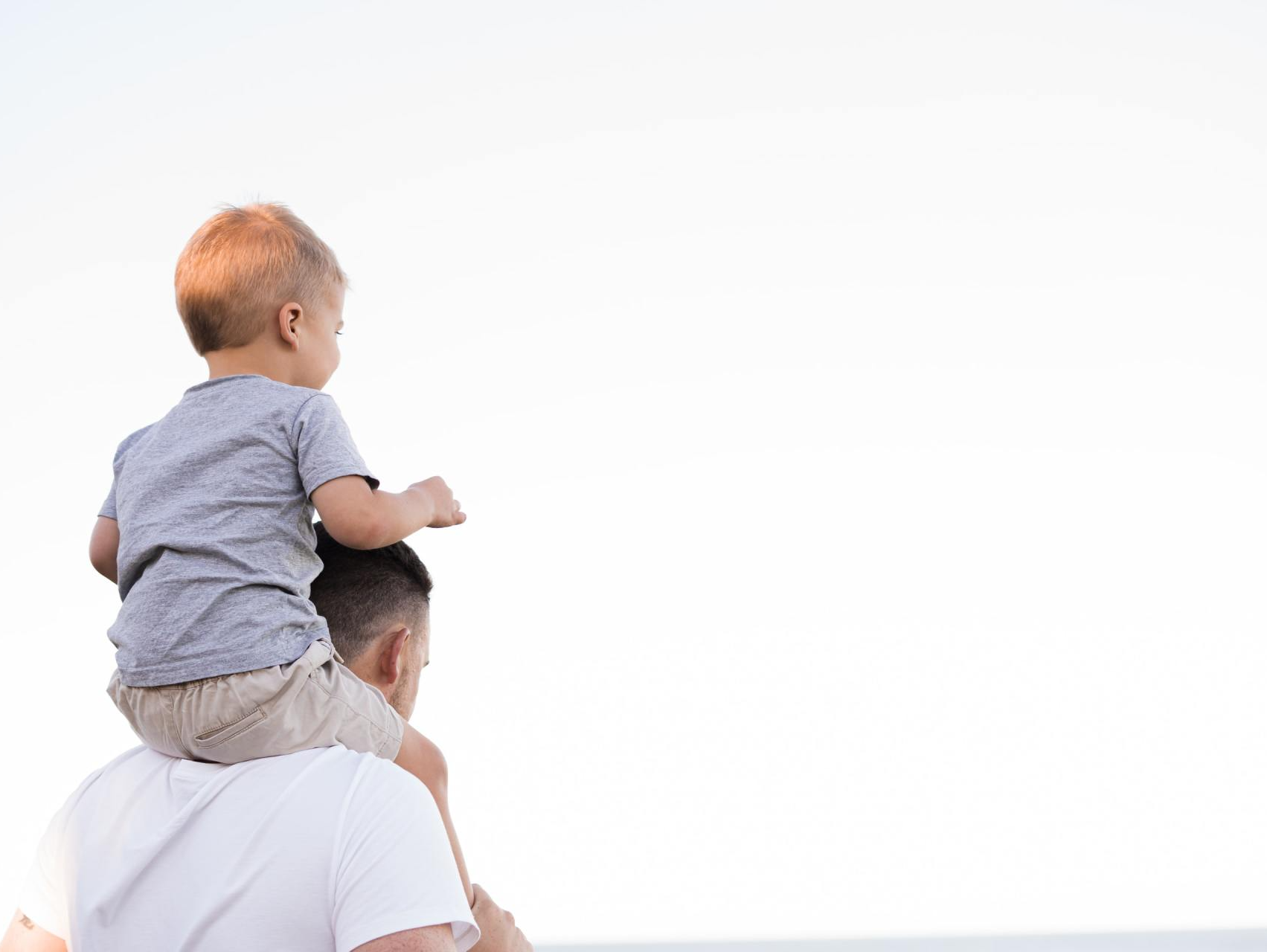 Photo of man with child on shoulders