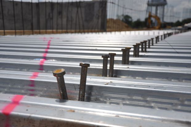 a bunch of nails are sitting on a metal surface