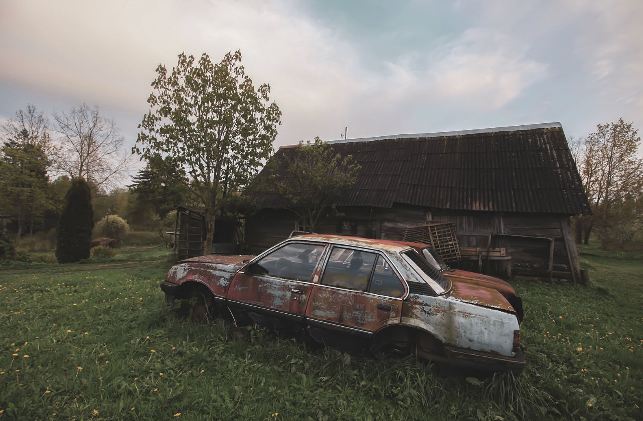 abandoned car in field 