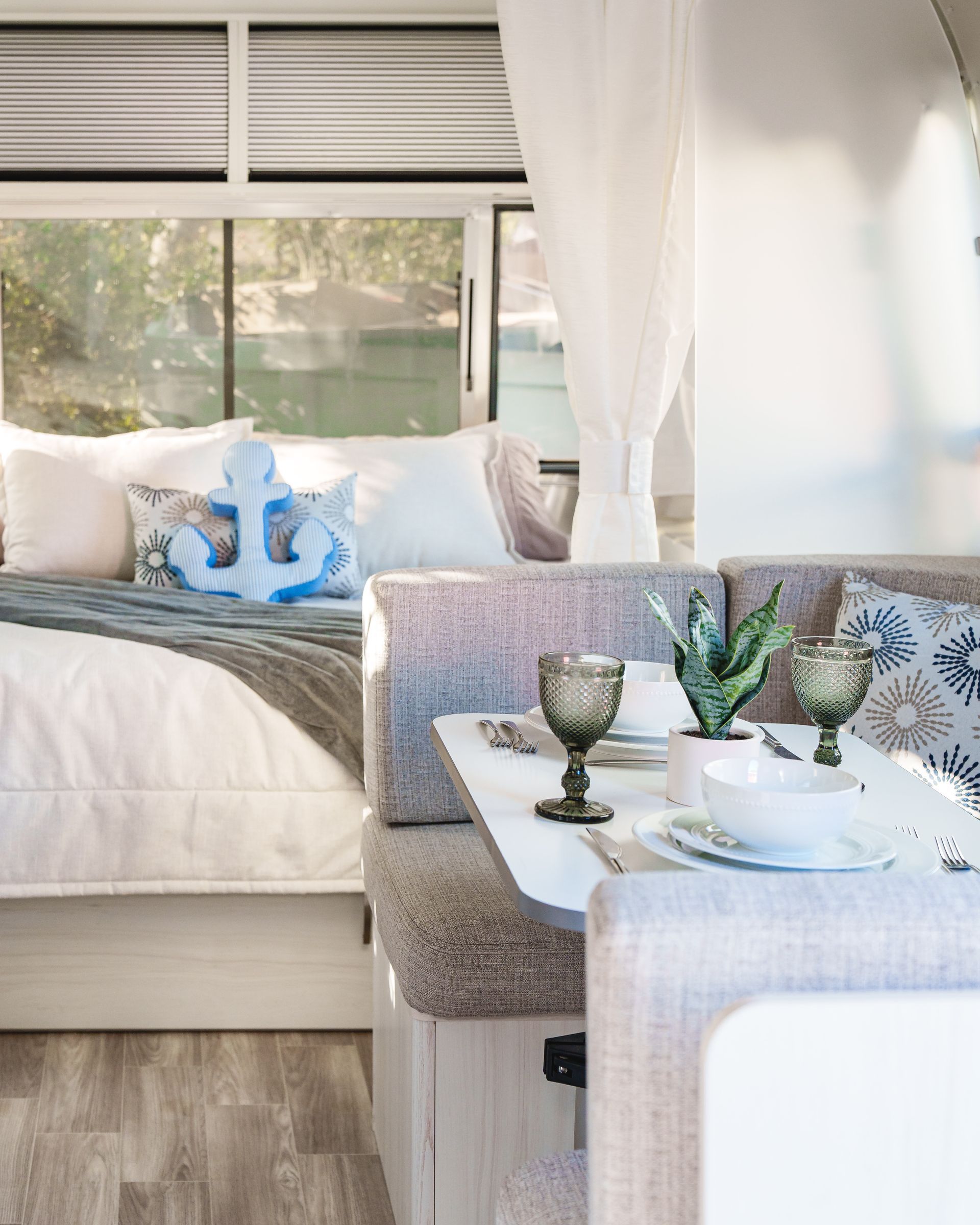 Minimal RV bedroom with natural light and ocean ambiance
