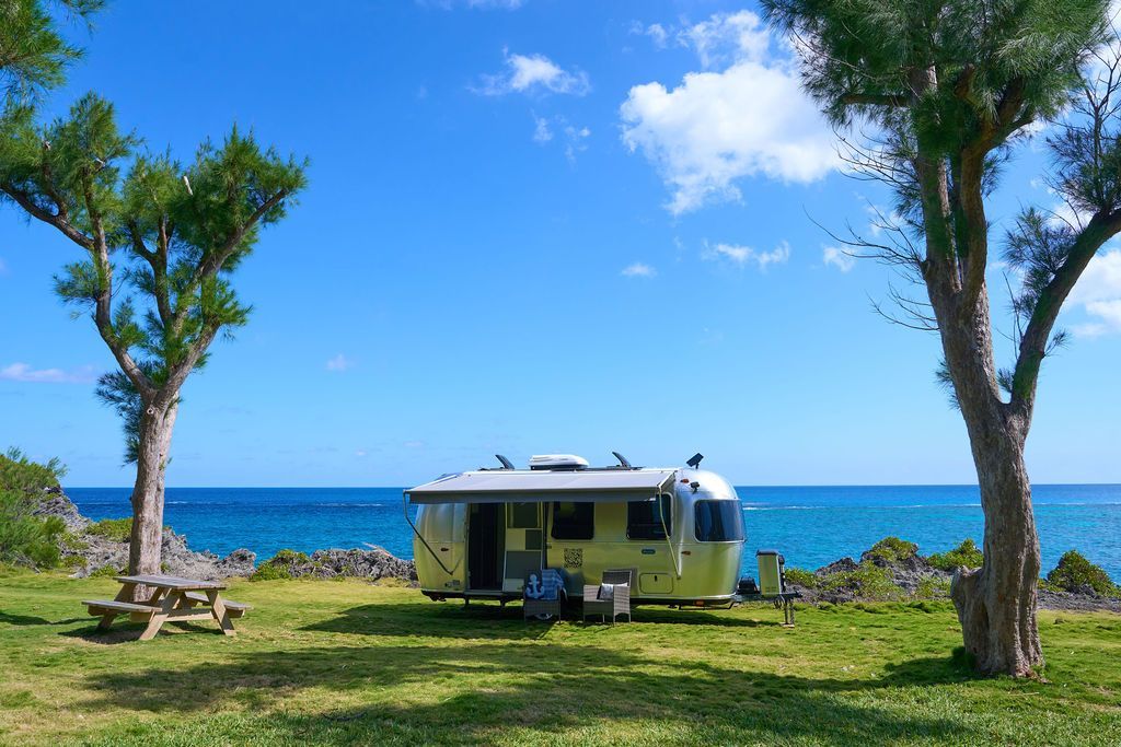 Off Grid RV surrounded by lush greenery near Watch Hill Park