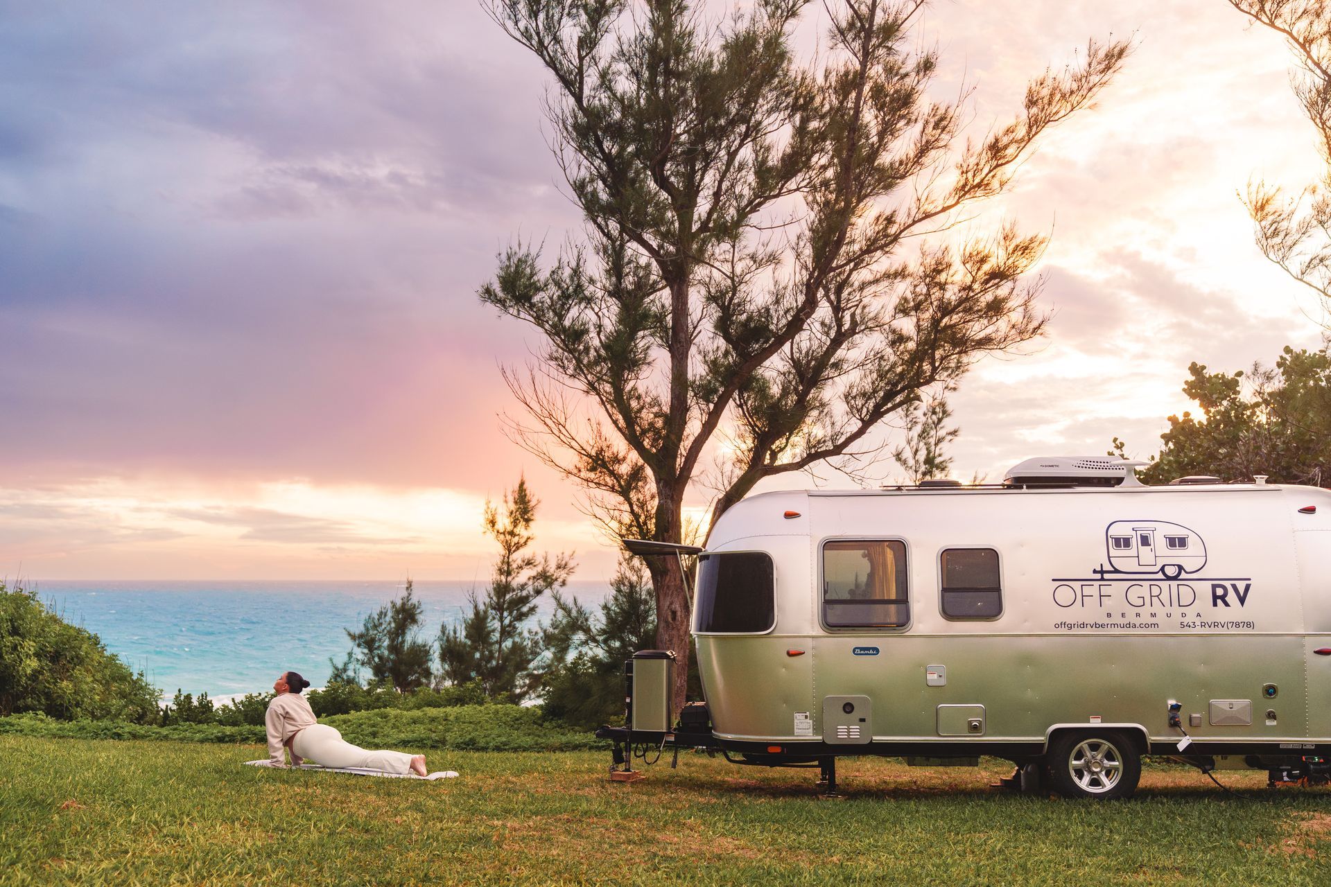 Off Grid RV parked near ocean trees at golden hour