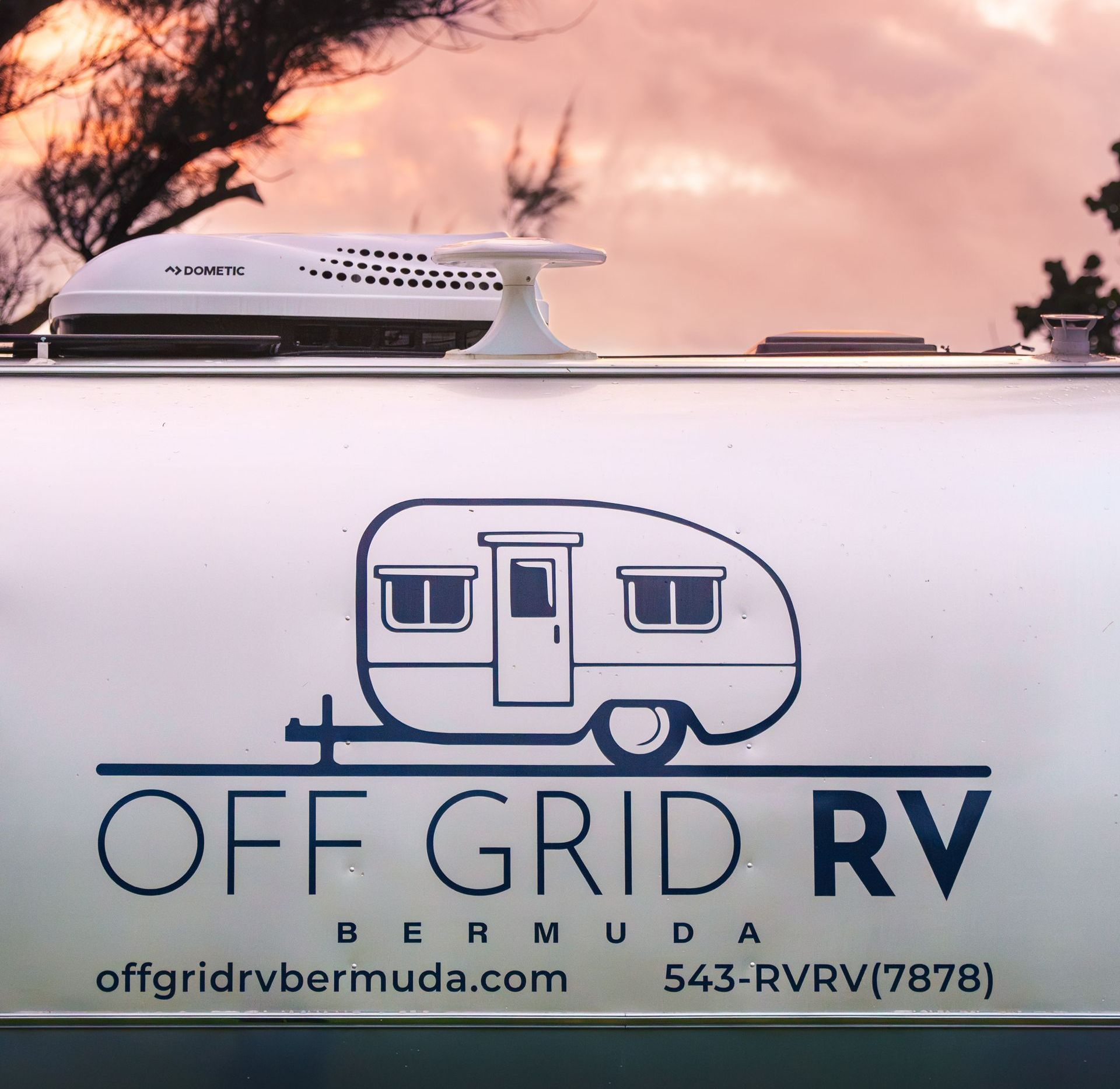 Luxury Airstream RV parked by the ocean during Bermuda sunset