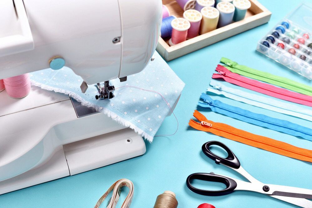 A Sewing Machine is Sitting on Top of a Blue Table — James Hunter Mobile Sewing Machine Mechanic in Maroochydore, QLD