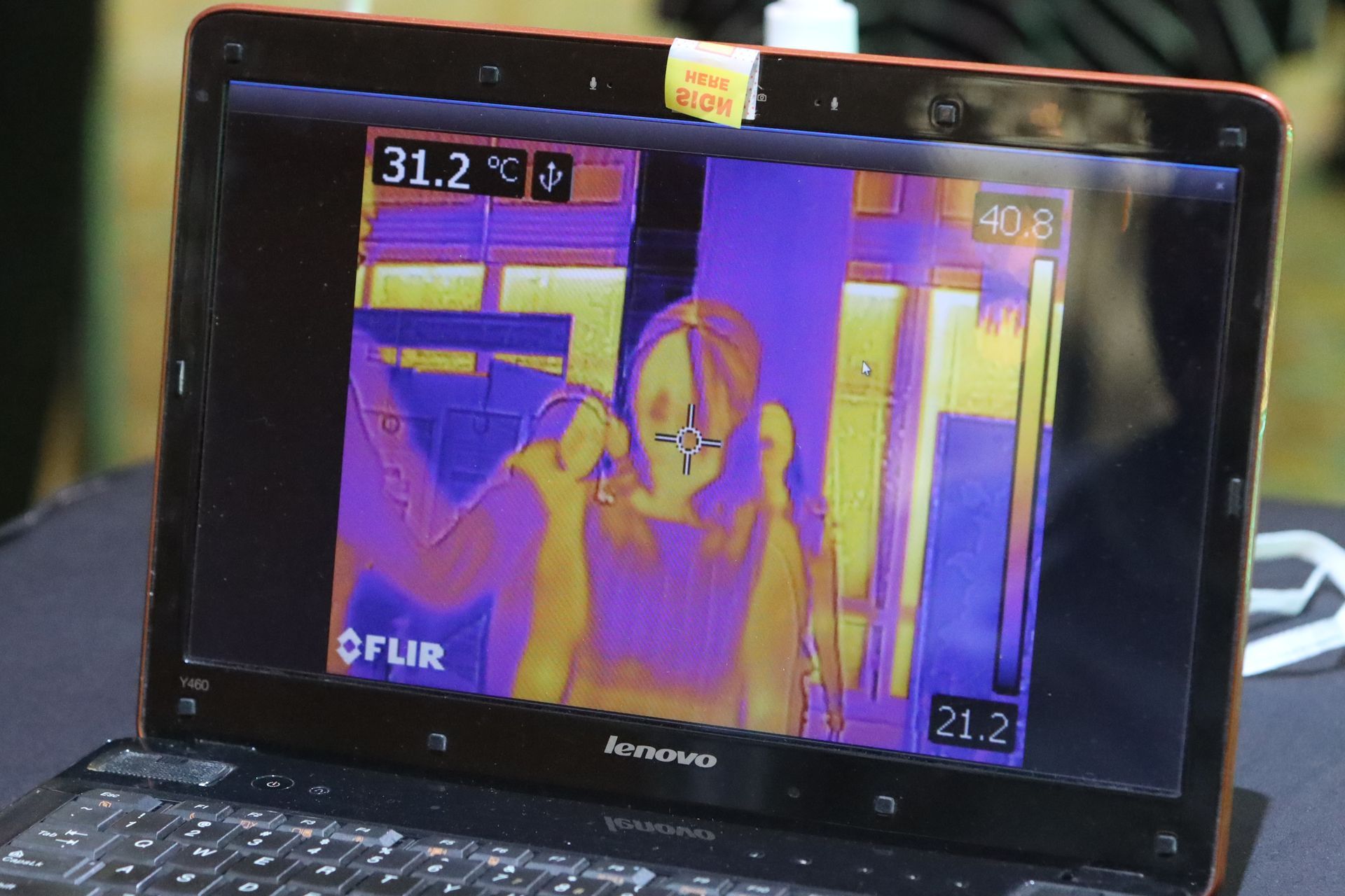 A thermal image of a person on a lenovo laptop