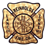 Vintage gold firefighter emblem reading “Reinholds Fire Co., Lanco. Co. Zone No. 1” with crossed axes and ladder