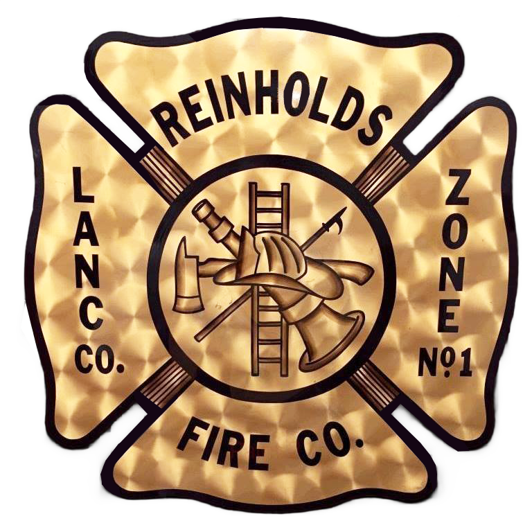 Vintage gold firefighter emblem reading “Reinholds Fire Co., Lanco. Co. Zone No. 1” with crossed axes and ladder