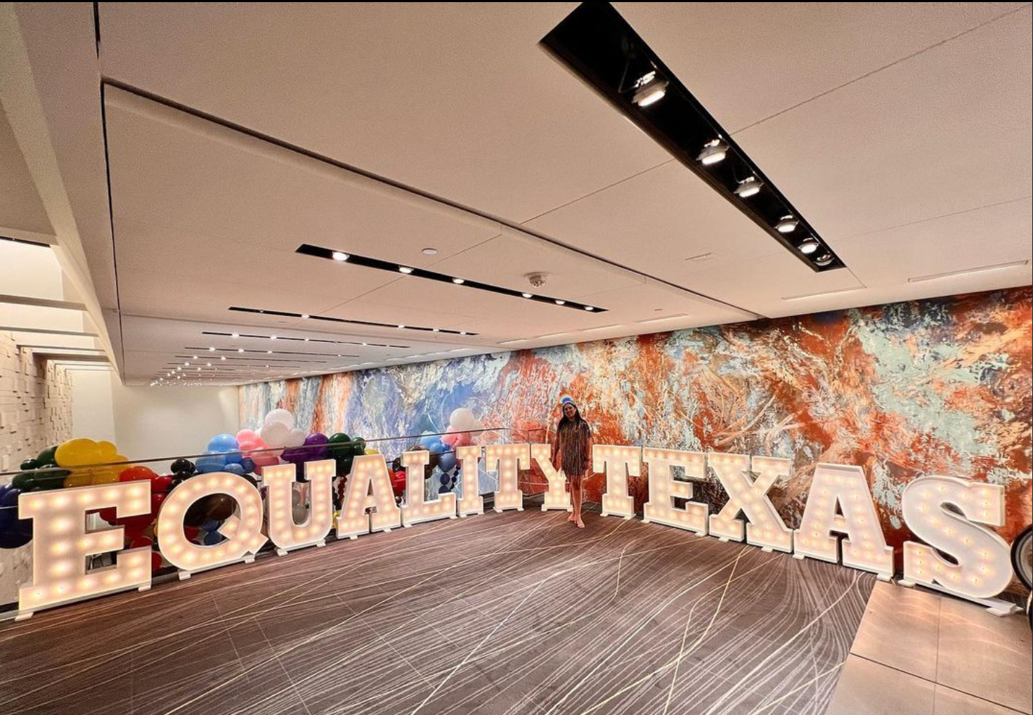 A large room with a sign that says equality texas