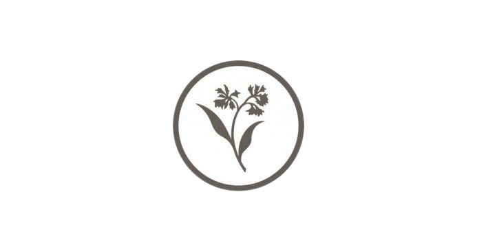 A gray circular logo with a delicate floral design inside.