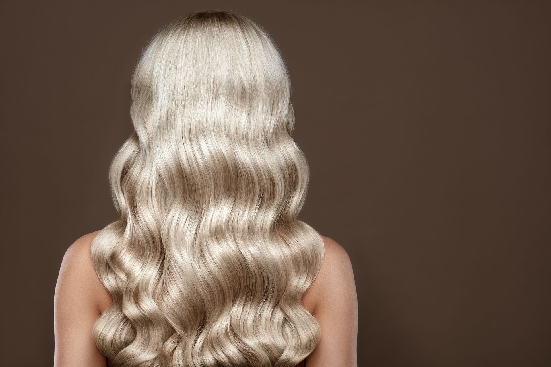 Hair extensions for blonde girl in a beauty salon. Hair extensions for blonde girl in a beauty salon.