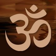 Om symbol in tan color, set against a blurred brown background.