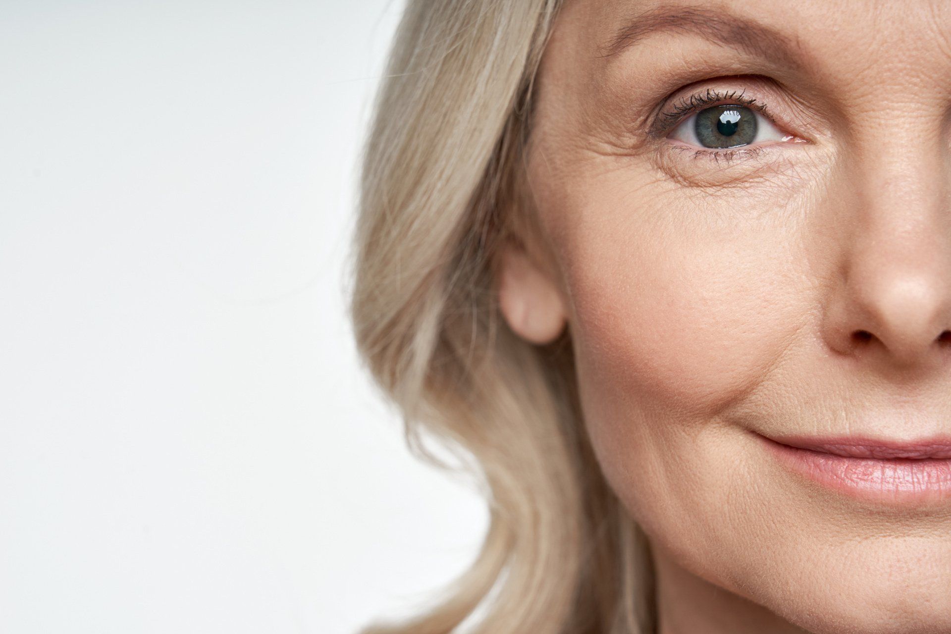 A close up of a woman 's face with a smile on her face.