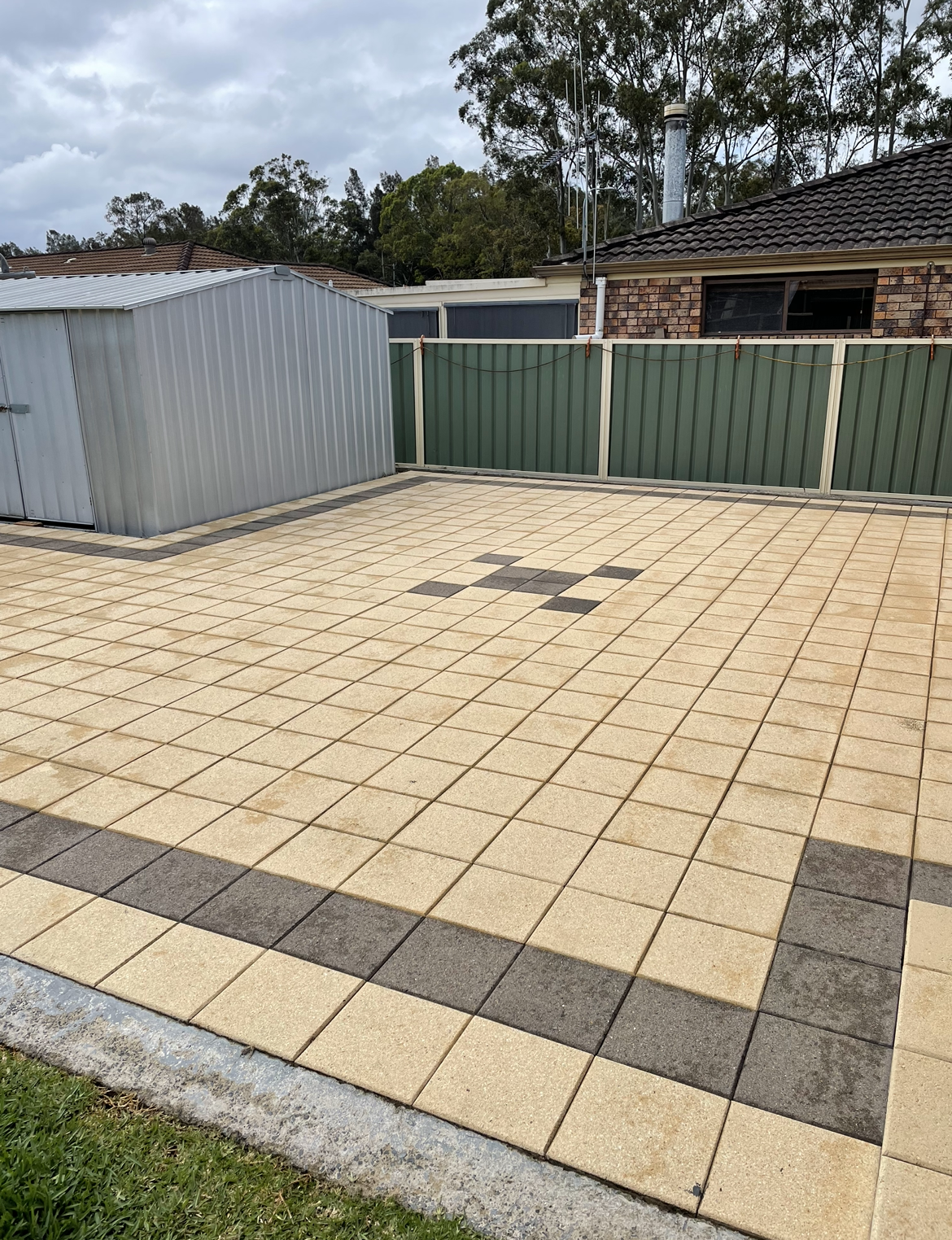 A Driveway with A Fence and A Shed in The Background After — Bulley Roof Restoration, Painting & Pressure Cleaning in Wingham, NSW