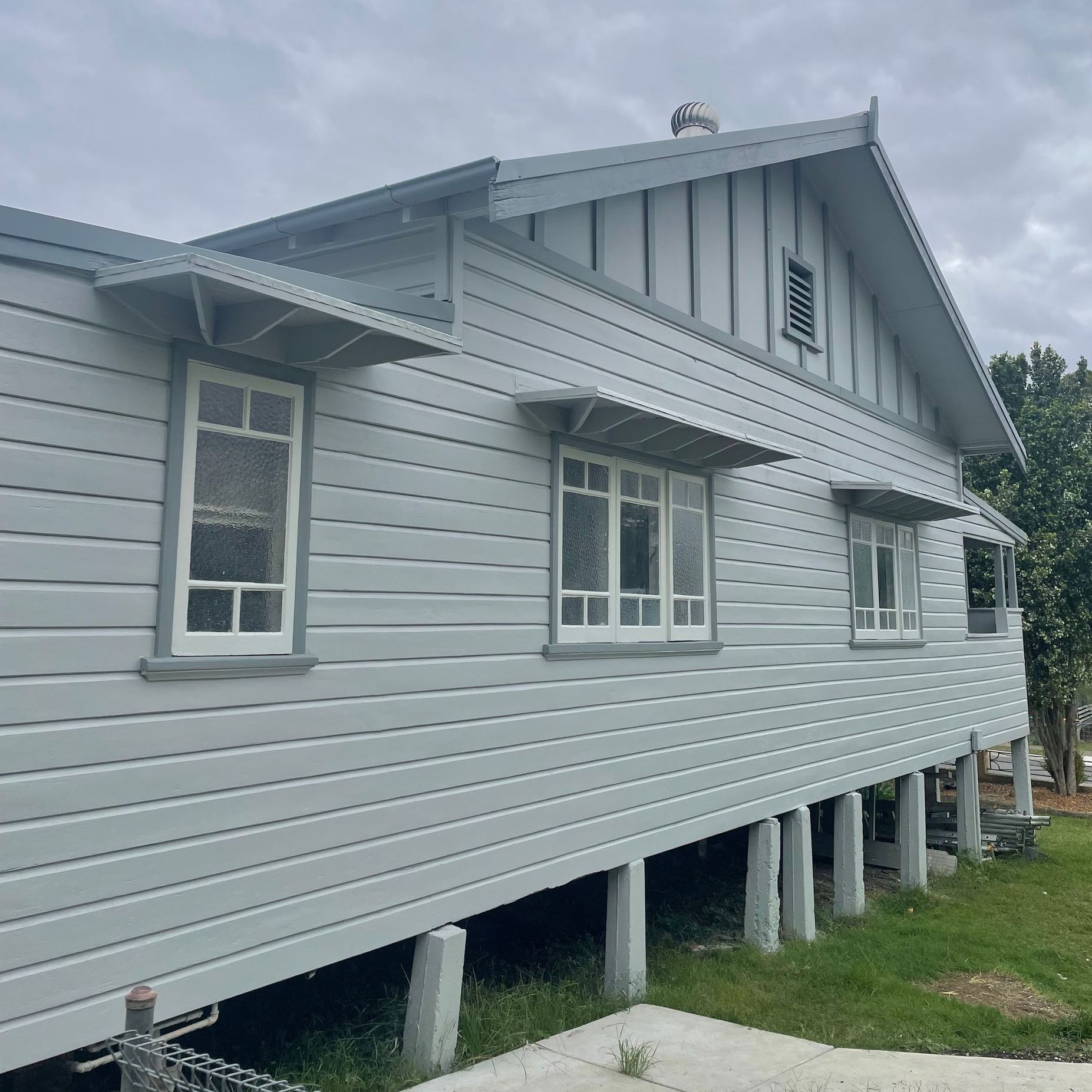 A White House with A Roof and A Lot of Windows After — Bulley Roof Restoration, Painting & Pressure Cleaning in Wingham, NSW