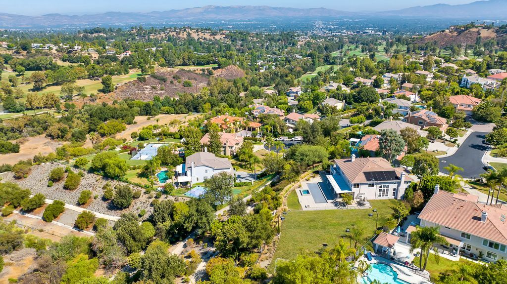 An aerial view of a residential area with lots of trees and houses.