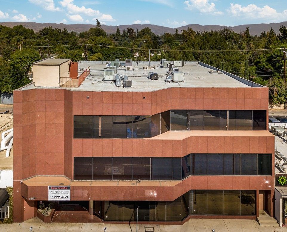 An aerial view of a large brick building with a lot of windows.