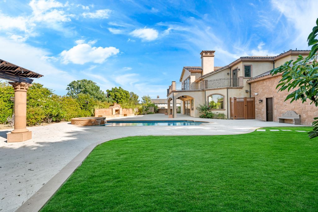 A large house with a swimming pool in the backyard.