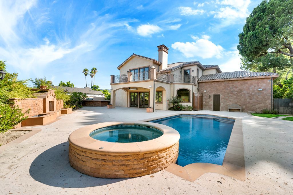 A large house with a large swimming pool in front of it