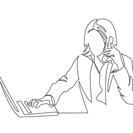 A woman is talking on a cell phone while using a laptop computer.