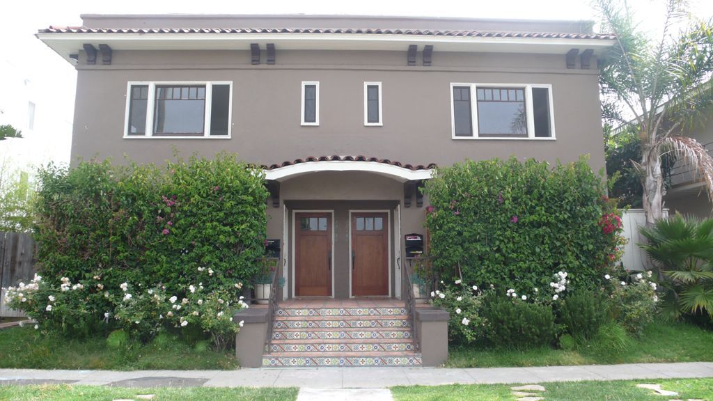 The front of a house with two doors and two windows