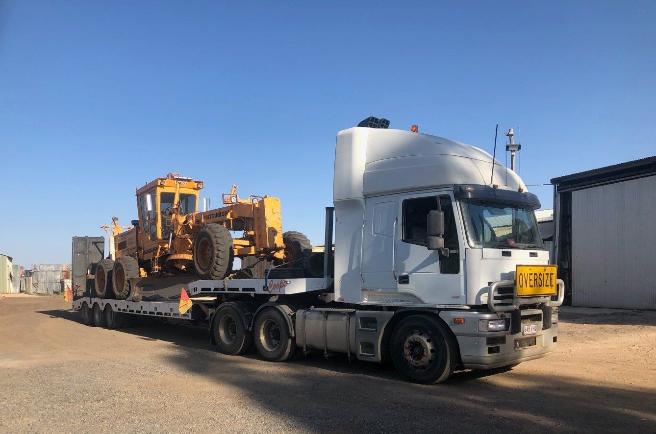 Truck Hauling Earthmoving Equipment