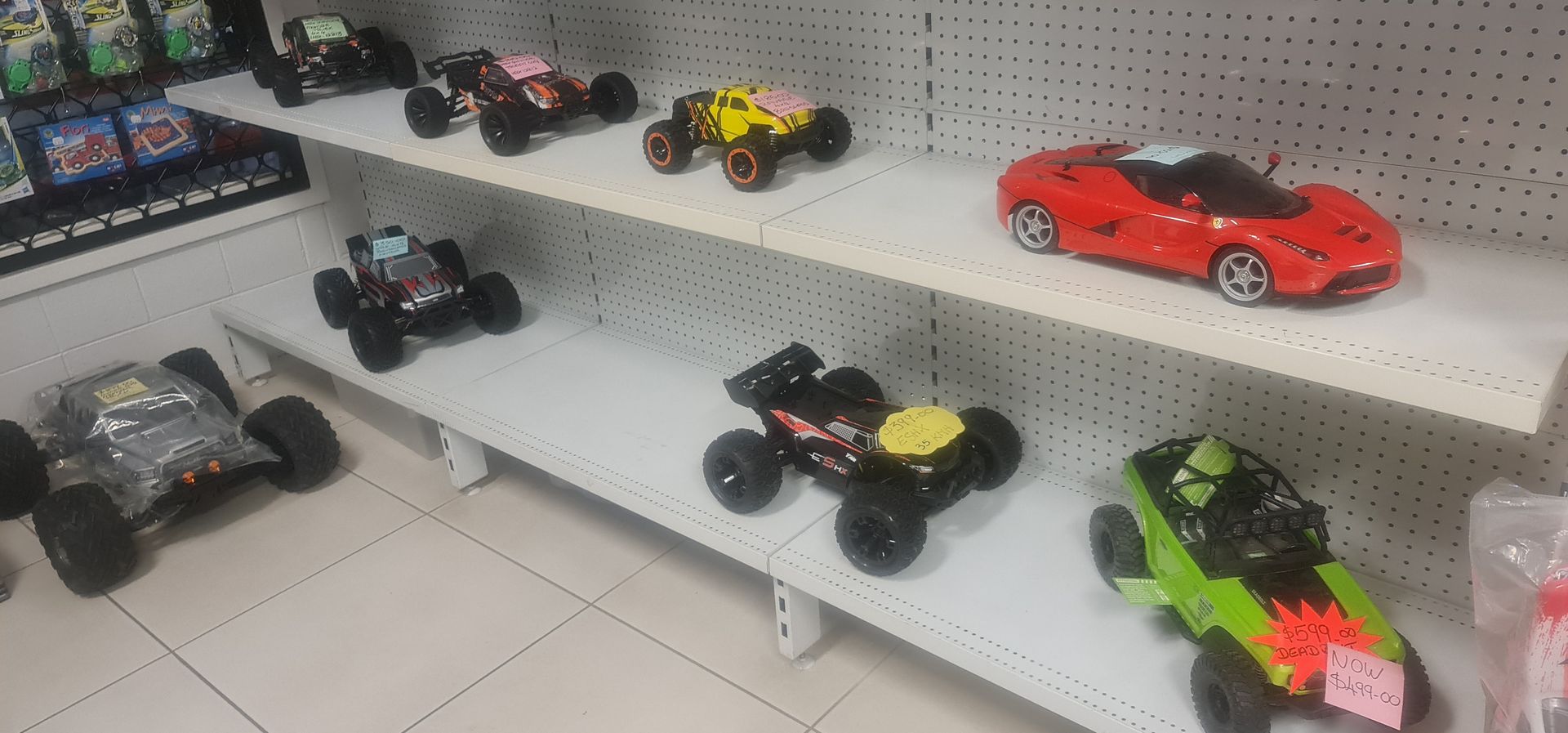 Shelves Displaying Various Toy Cars — Central Western Communications in Emerald, QLD