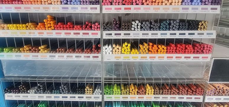 Shelves of Colourful Pencils Organized by Colour in a Store — Central Western Communications in Emerald, QLD