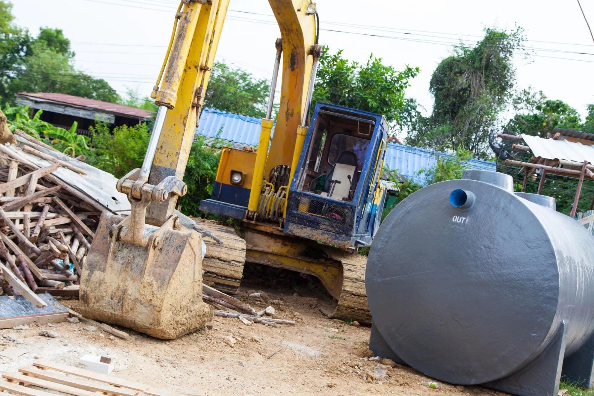 backhoe and a metal septic tank