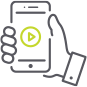 A hand is holding a cell phone with a play button on the screen.