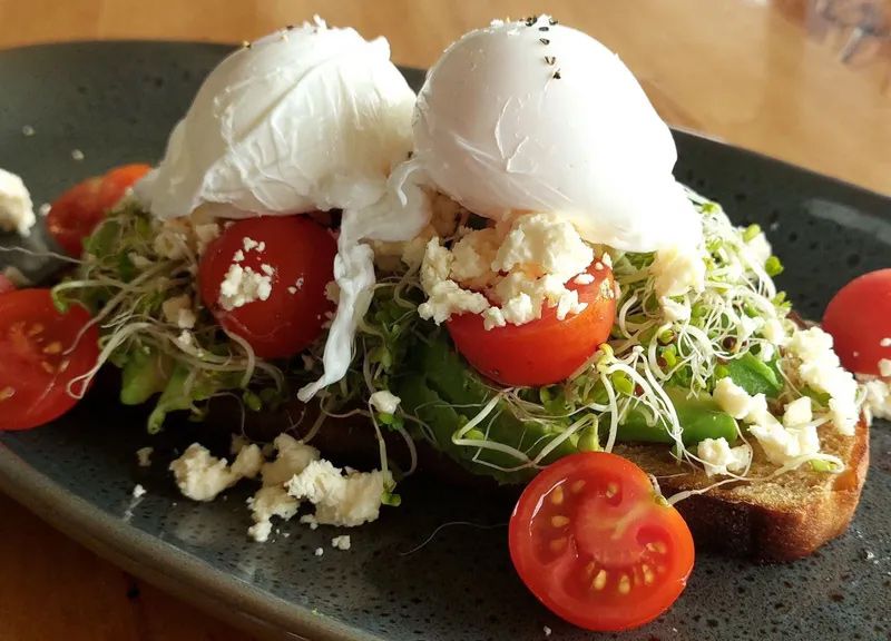 A Close Up of a Plate of Food With Tomatoes and Poached Eggs — Coffee on High in Wauchope, NSW
