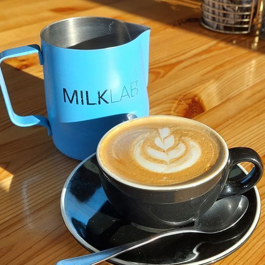 A Cup of Coffee Next to a Pitcher — Coffee on High in Wauchope, NSW