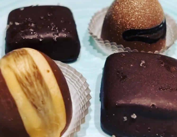 Four different types of chocolates are sitting on a table