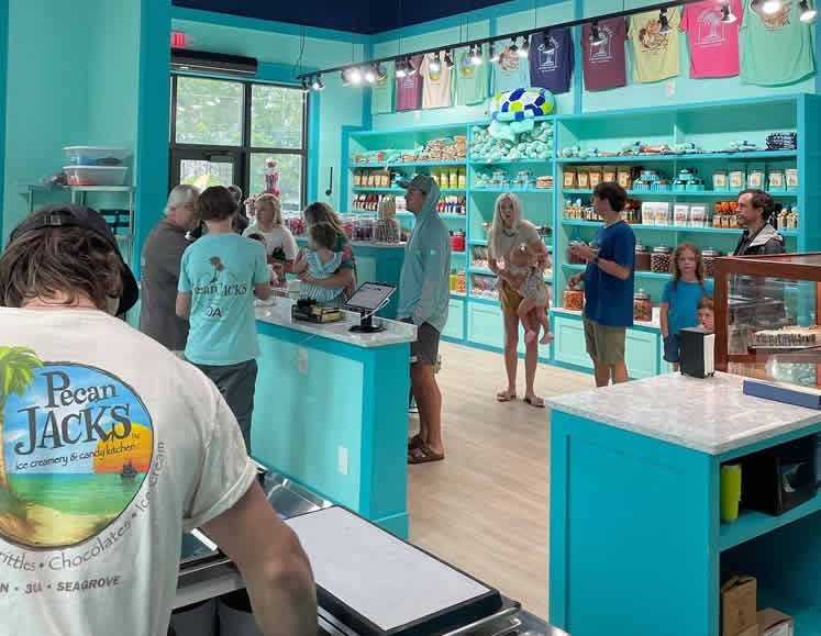A group of people are standing around a counter in a store.