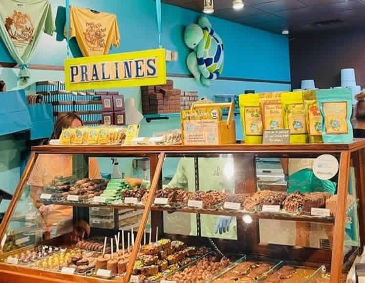 A display case with a sign that says pralines on it