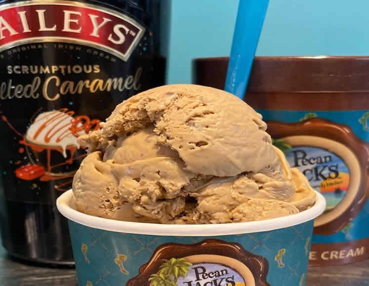 A cup of ice cream next to a jar of baileys