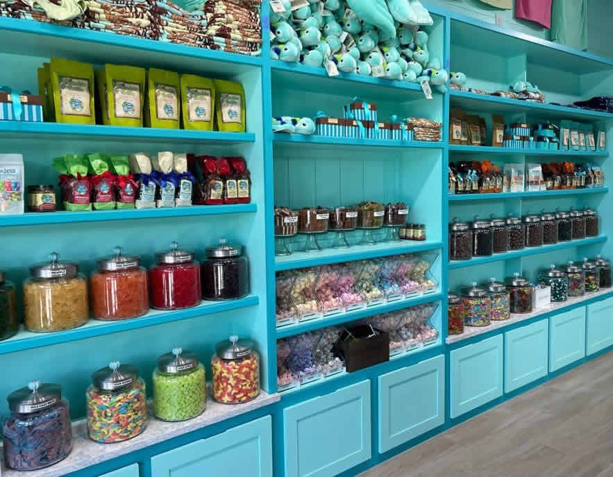 A candy store filled with lots of jars and shelves.