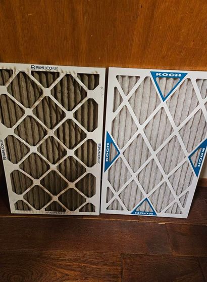 Two rectangular air filters, one dirty and brown, the other clean and white, are displayed side-by-side.