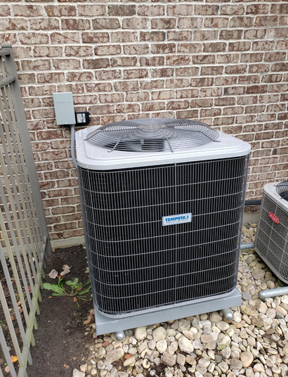 Furnace and air conditioner unit in a basement setting, with ductwork and a cooler nearby.