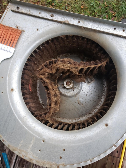 Open electrical box with copper contacts and wiring, including red, black, green, and silver wires, outdoors.