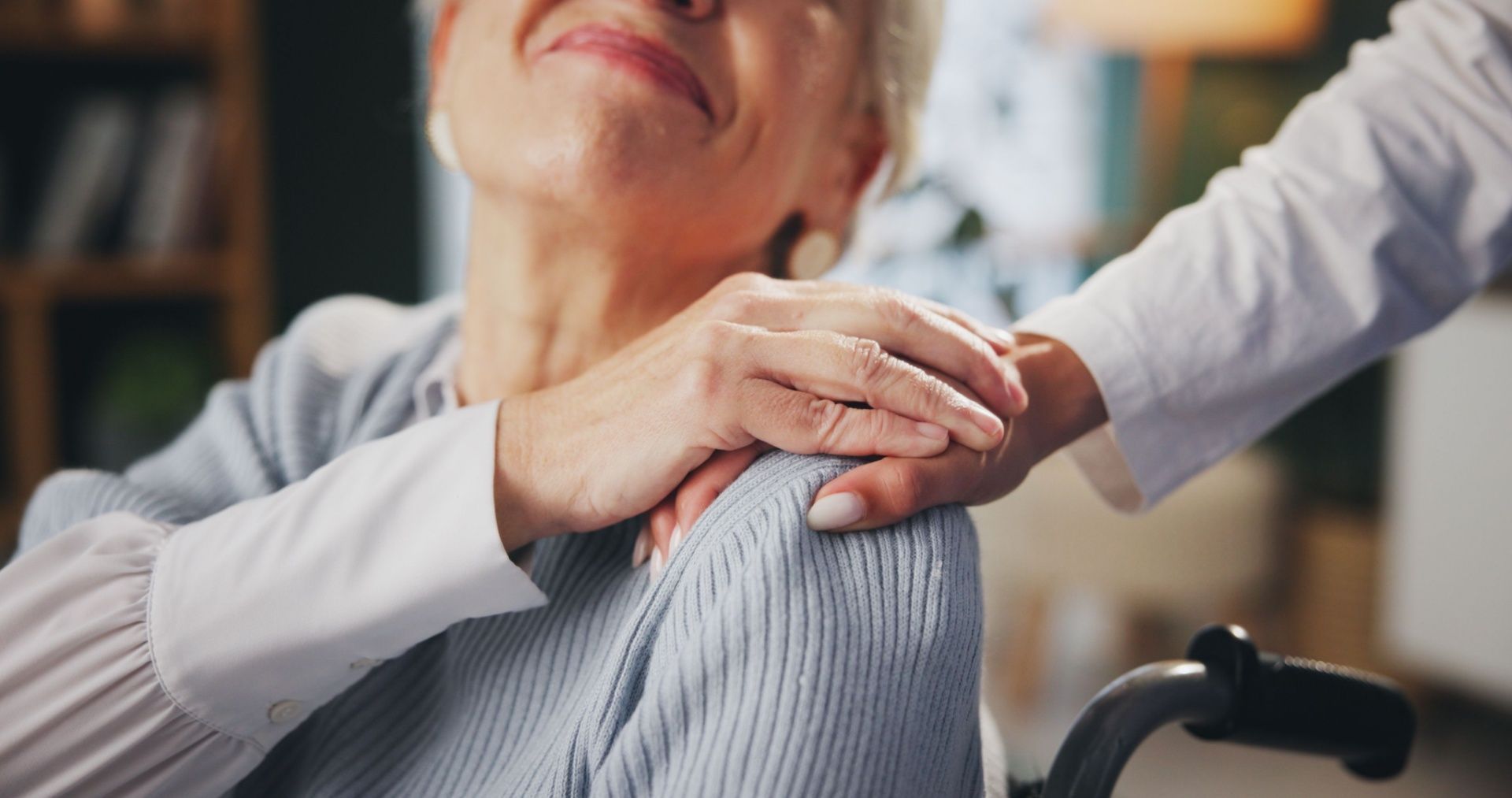 Hand on shoulder of a woman, offering comfort.