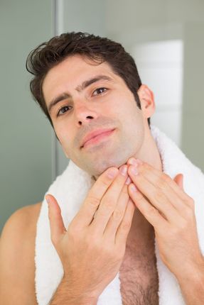 A close up of a woman 's face with her hands on it.
