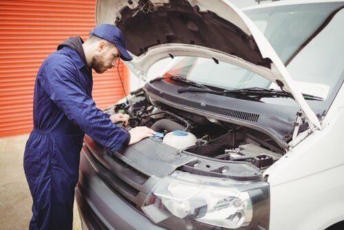 Mechanic in Blue Jumpsuit Checks — Sparky's 4x4 Auto Electrical In Taminda, NSW