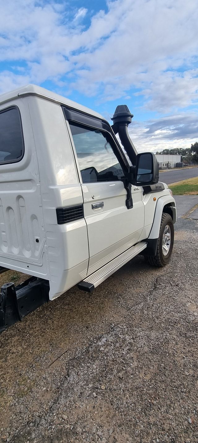 White Toyota Land Cruiser with Snorkel and Running Boards Parked on Gravel — Sparky's 4x4 In Armidale, NSW