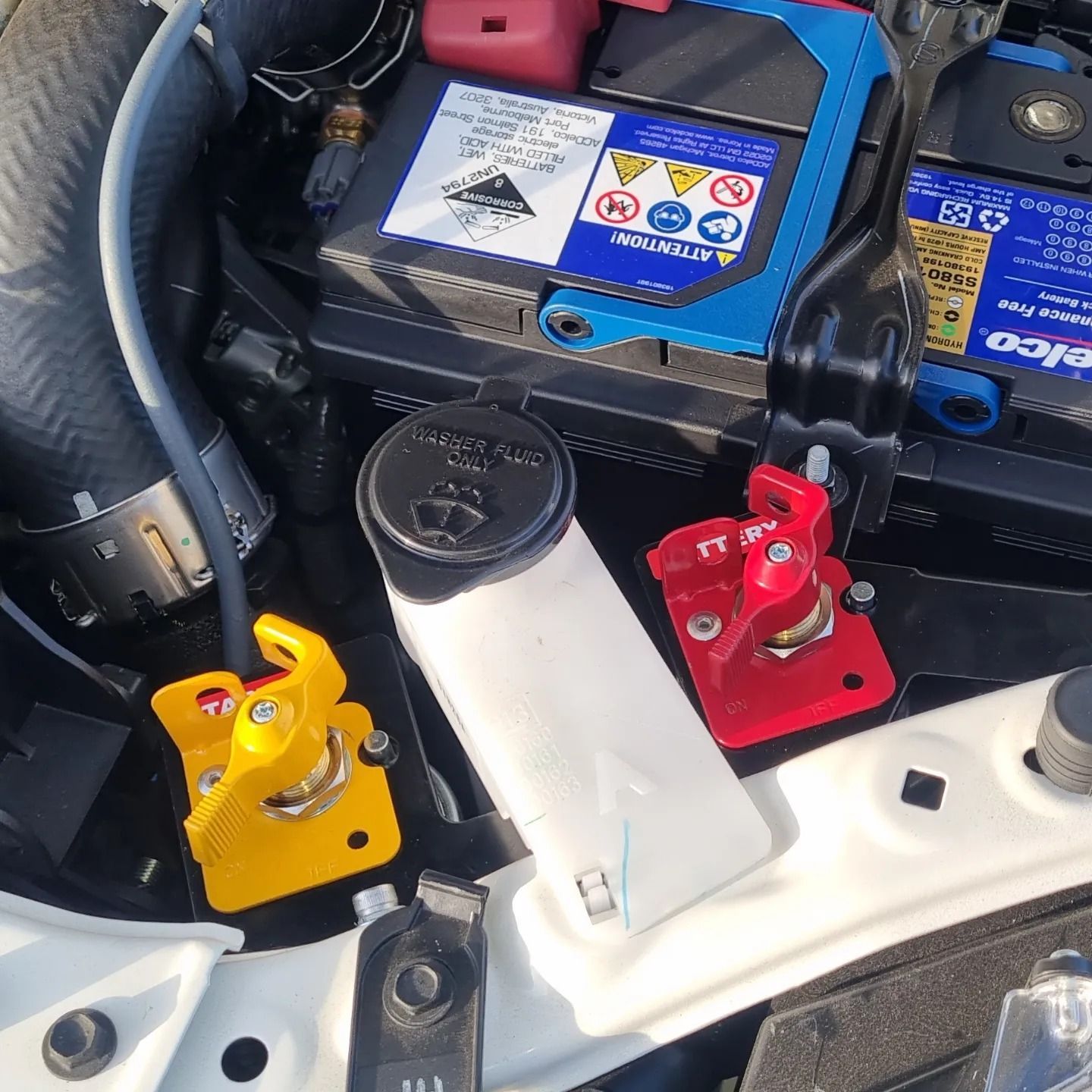 Car Engine Bay with Battery, Various Colored Clamps, and Fluid Reservoir — Sparky's 4x4 In Taminda, NSW